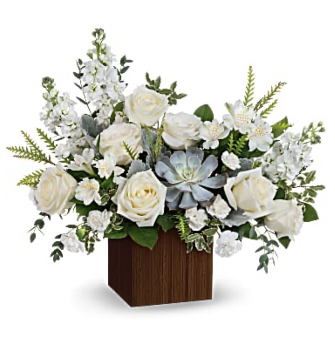 White roses and mixed white flowers in a wooden cube vase