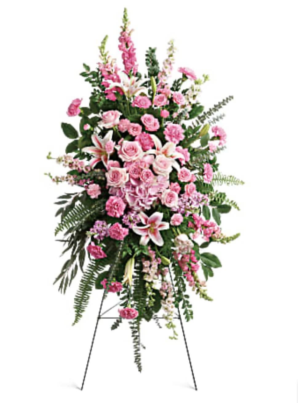 Tall pink funeral spray on a stand with lilies and roses