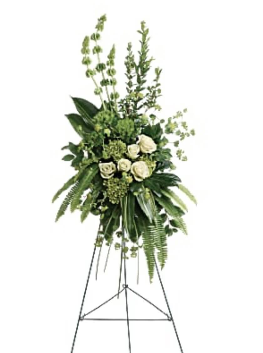 Tall white rose and greenery standing spray on an easel