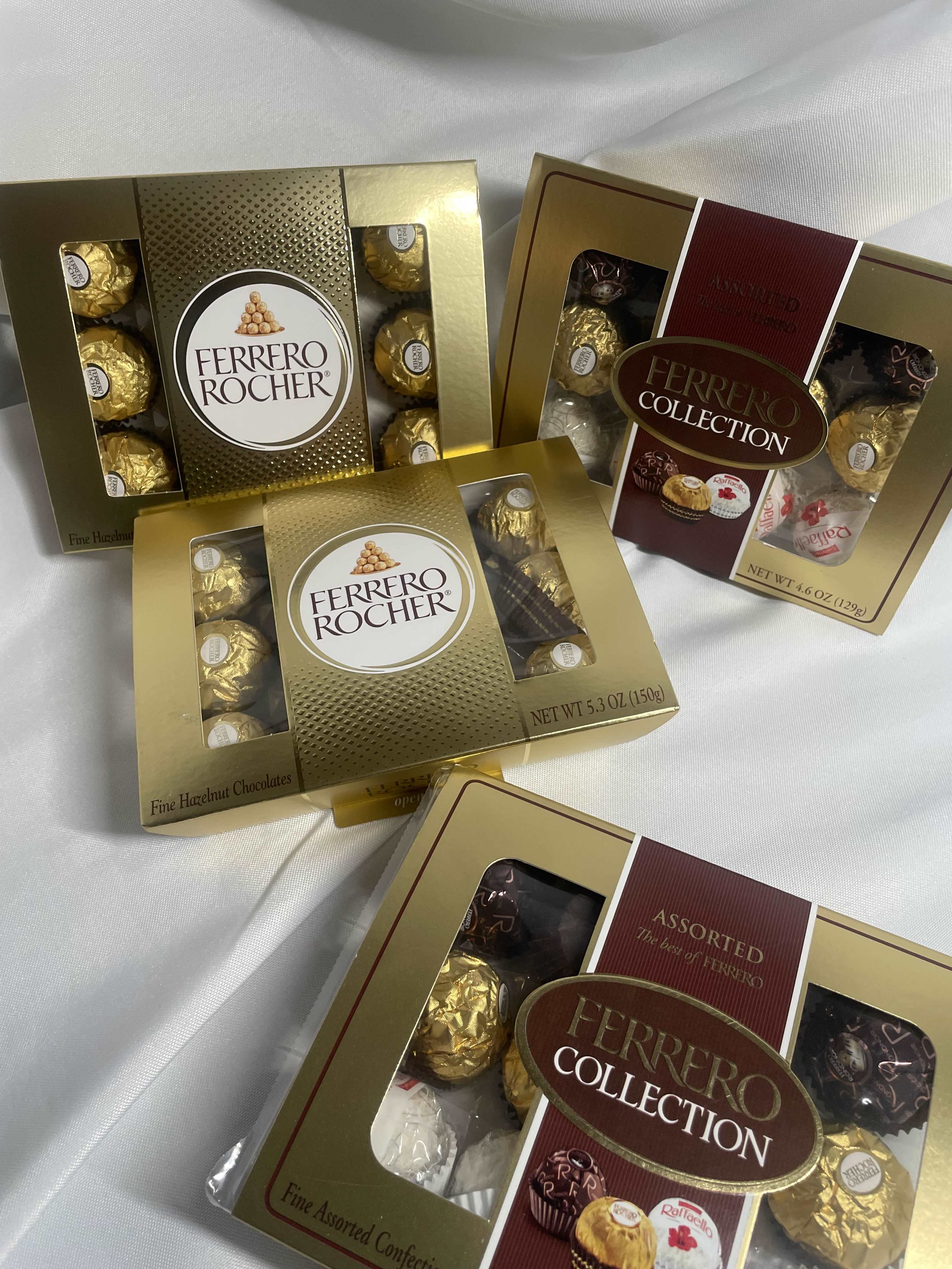 Boxes of Ferrero Rocher chocolates on white fabric
