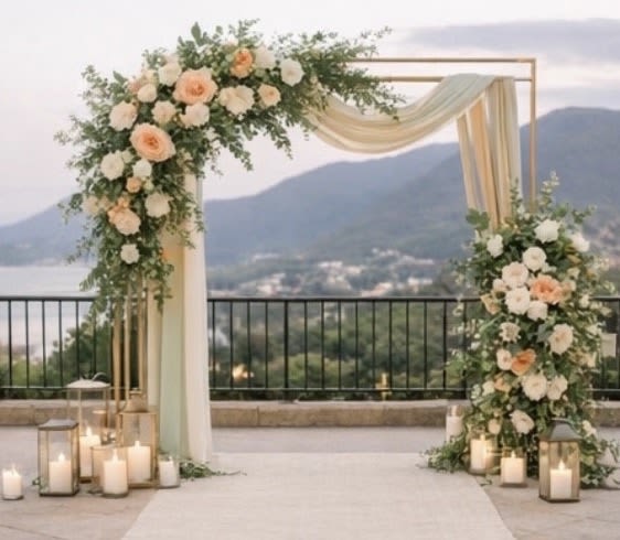 Floral wedding arch with peach and white roses and draped fabric