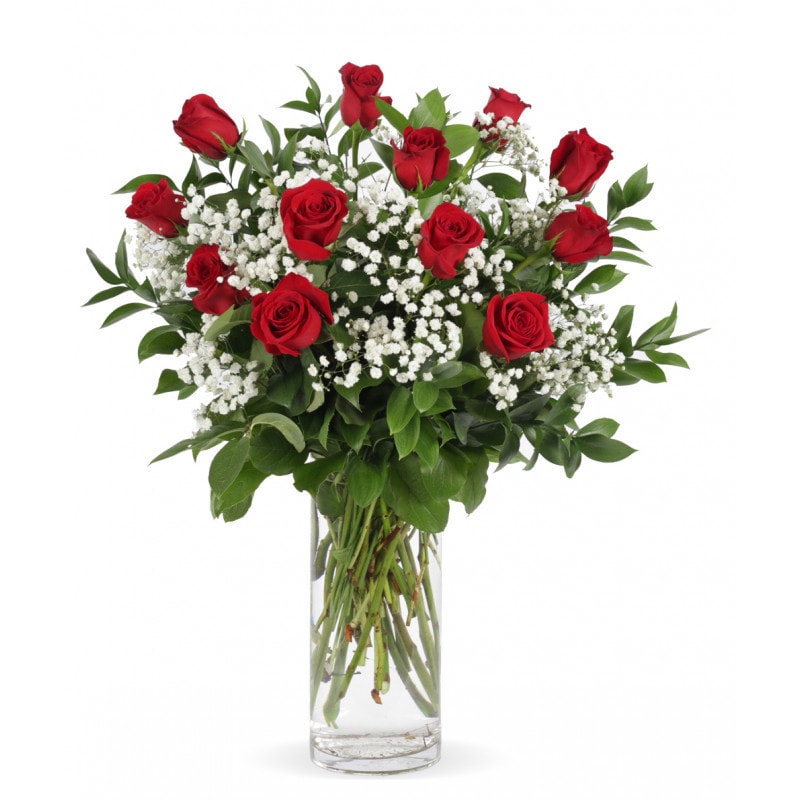 red rose bouquet - you can never go wrong with classic red roses! 12 long stem red roses loosely designed in a tall clear gathering vase with seasonal greenery and accented with babies breath. Red roses are not only a symbol of love, longing, and desire, but they can also convey emotions such as respect, admiration, and devotion.