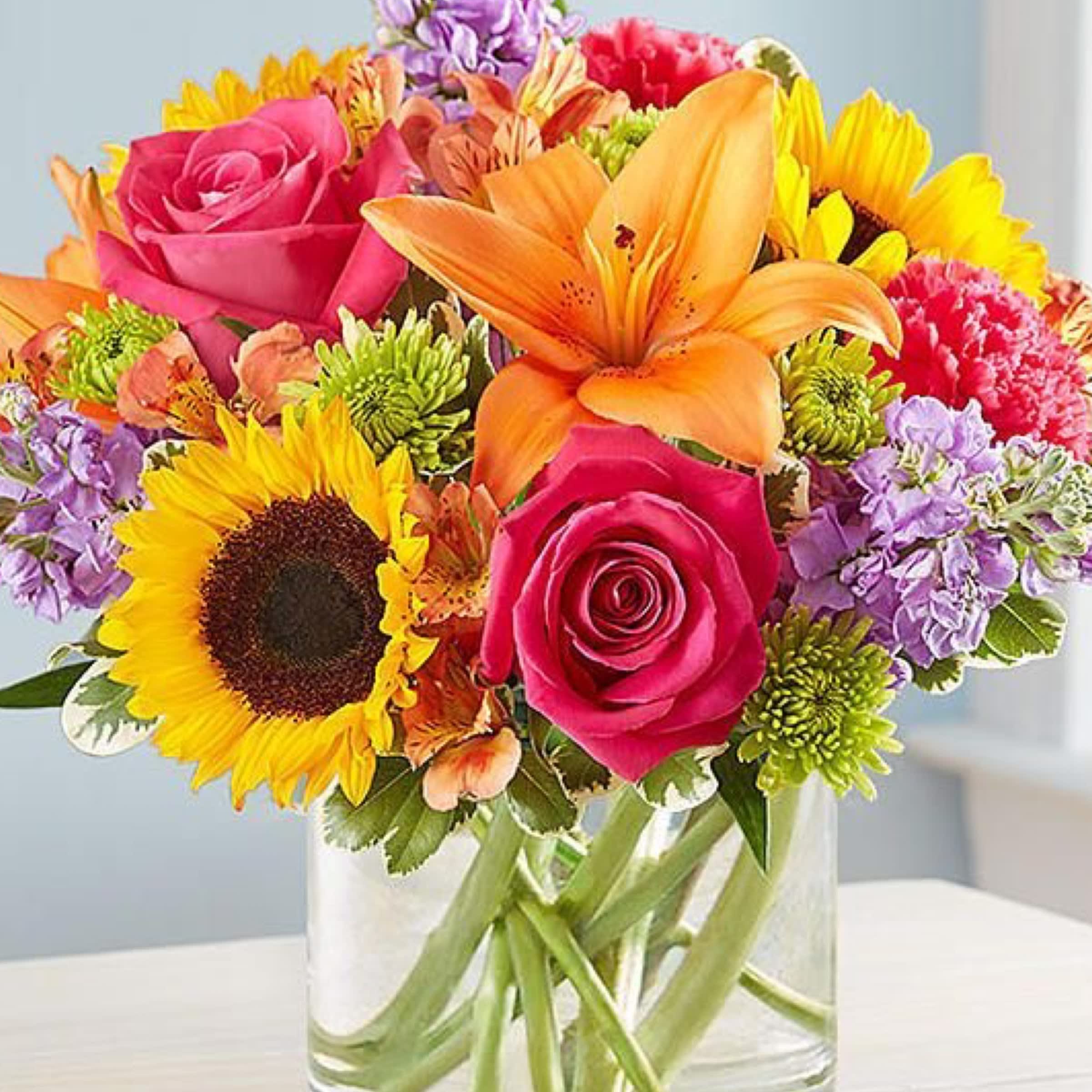 Embrace sunny Flower - sunflower,hot pink astromerias ,green cushions lovely this flowers