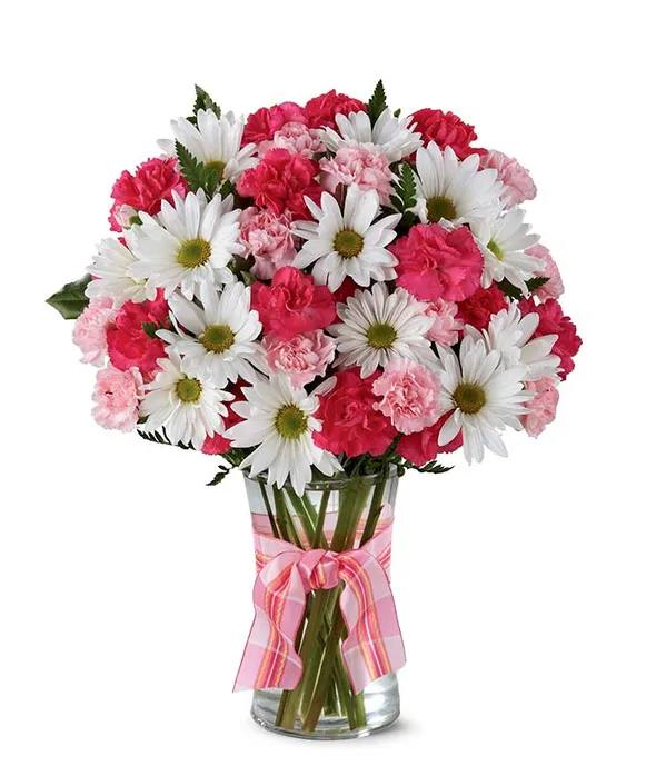 red and pink surprise - urprise Bouquet. Hand arranged with Hot Pink Spray Roses, White Daisies and Pink Mini Carnations this bouquet is perfect for a friend or a significant other. While the roses add a touch of love, the daisies add a touch of friendship. The three flower stems are placed in a clear glass vase that is decorated by a florist partner with a ribbon. Please note that in the regular size of the bouquet roses will not be included.