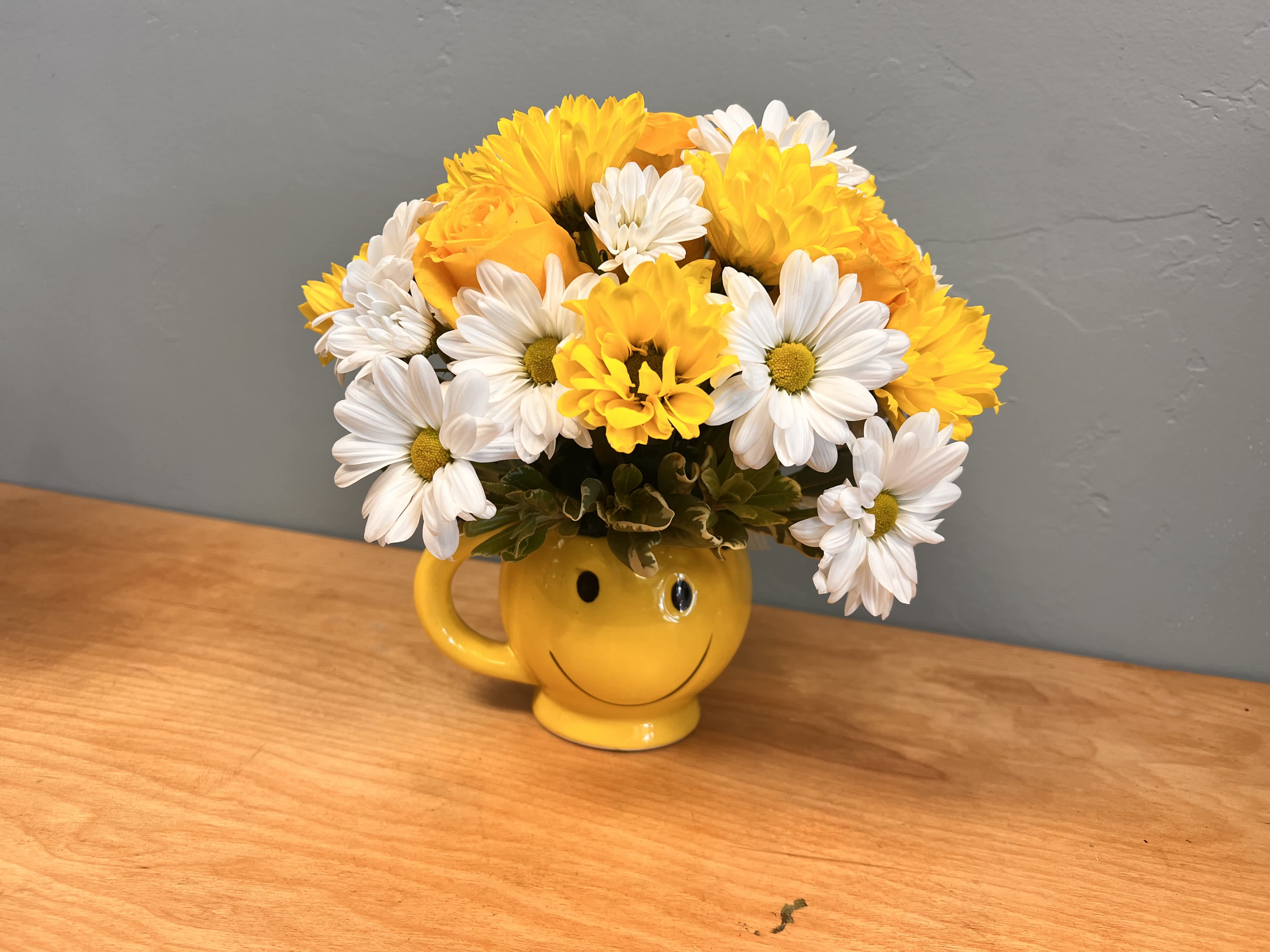Joy - Happy face tea cup with yellow and white daisies along with yellow roses