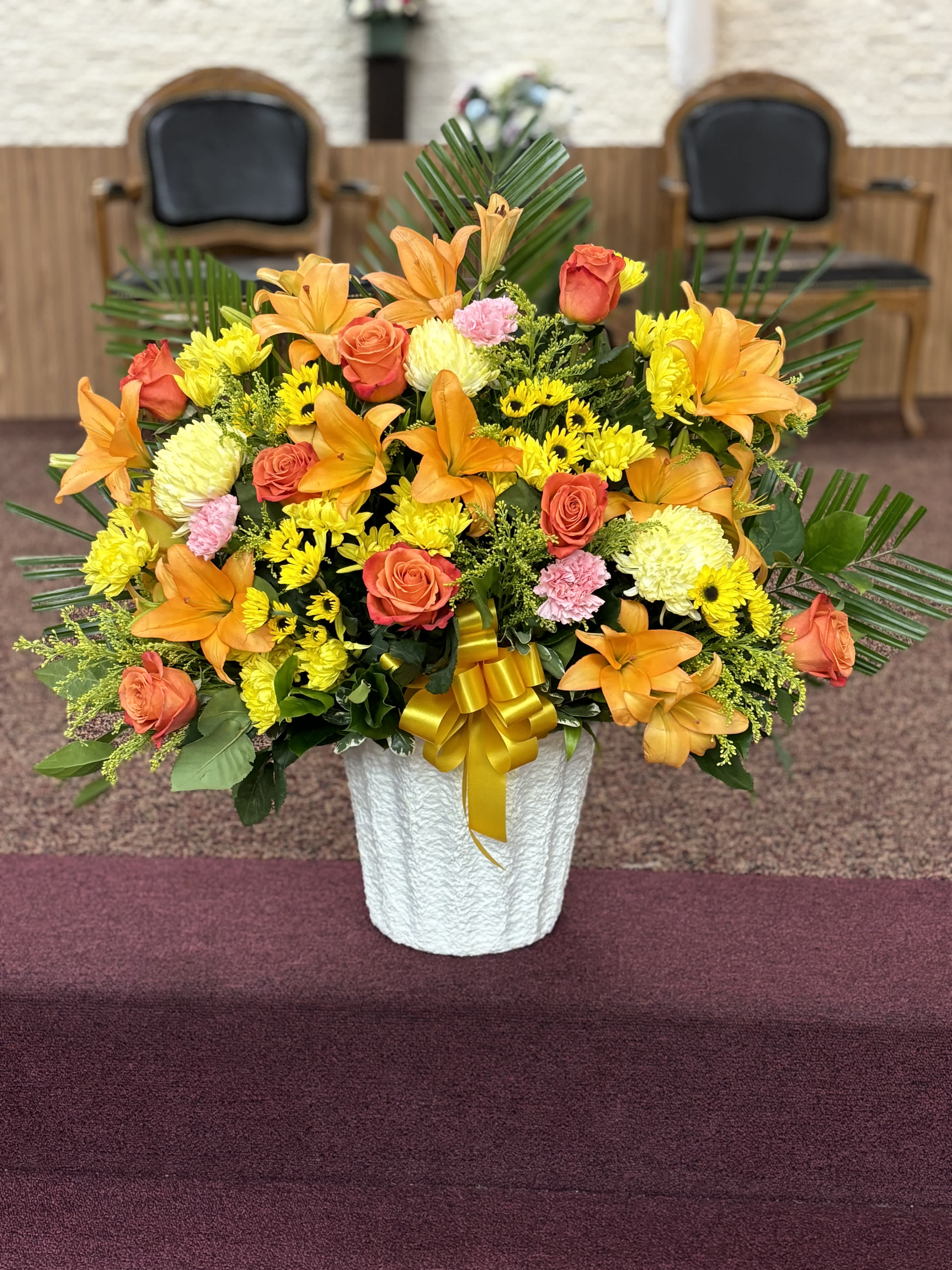 Heartfelt Tribute Bright Floor Basket - Statice Purple		STEM	3 Solidago		STEM	11 Viking Pom Yellow		STEM	8 Spider Mum Yellow, Leather Leaf,	Asiatic Lily Orange, Carnation Hot Pink, Monte Casino Purple, Carnation Red, Emerald		 Rose Orange
