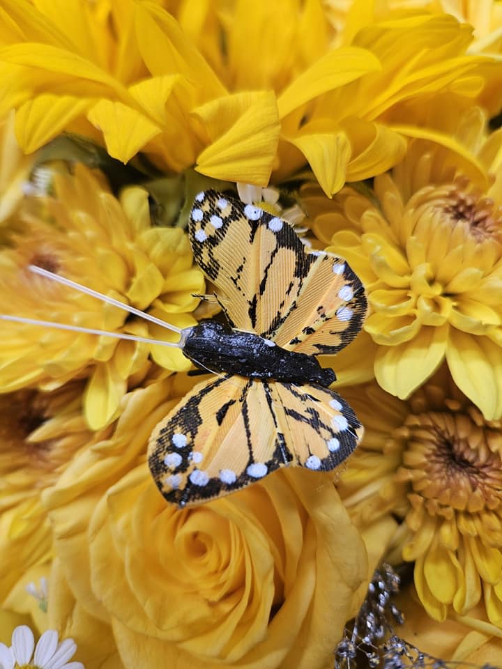 Yellow flower bouquet with a decorative butterfly pick
