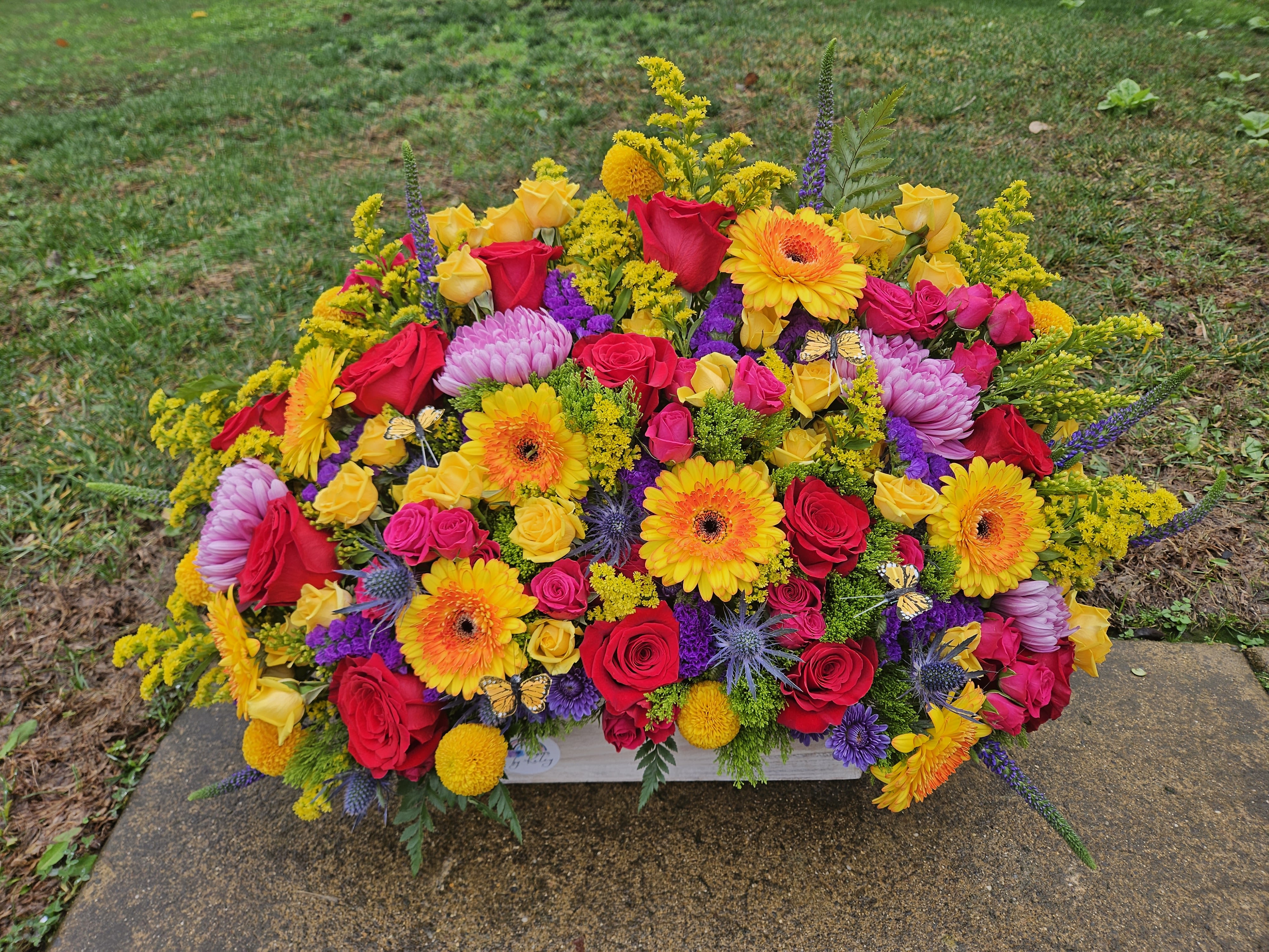 Bright mixed flower arrangement with roses, gerberas, and chrysanthemums