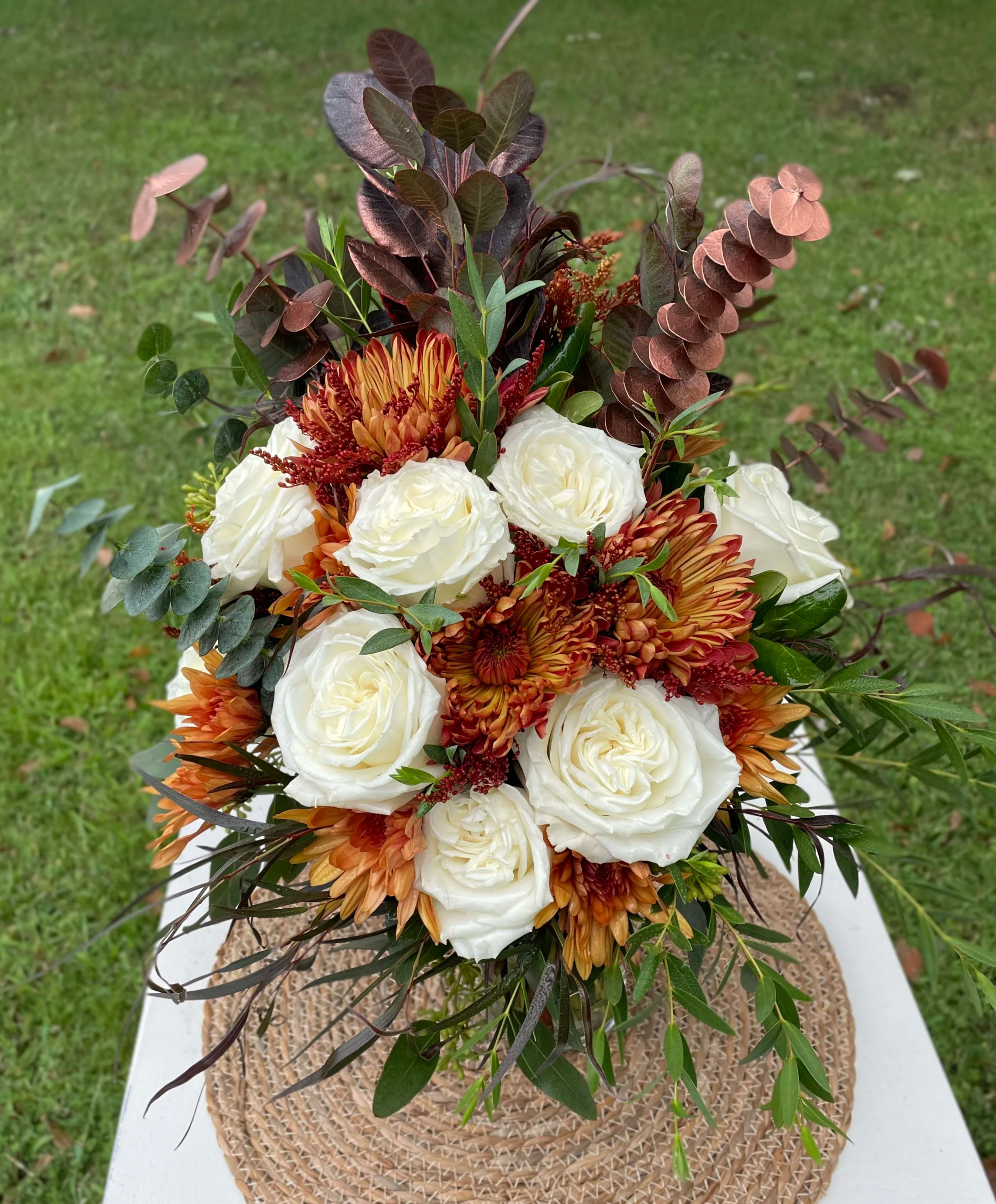 Fall Bridal Bouquet.  - Bridal bouquet with a mixture of cream and copper colored flowers, burgundy, and copper colored greenery accents. Varieties of flowers vary at brides request. 