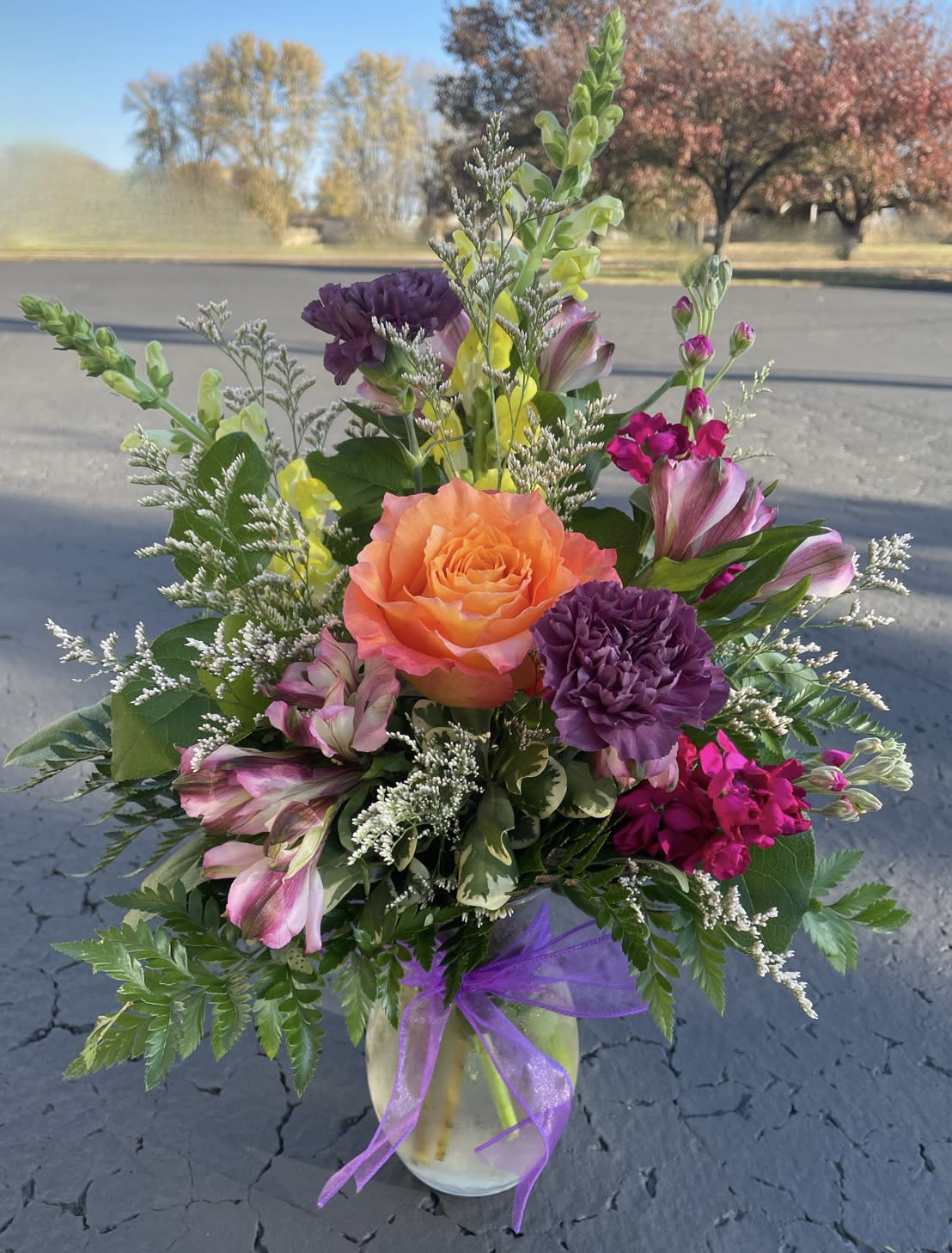 Picked Fresh - Adorable vase of flowers that give the impression they came straight from your dream flower garden. Filled with snapdragons, stock, roses, and carnations. 