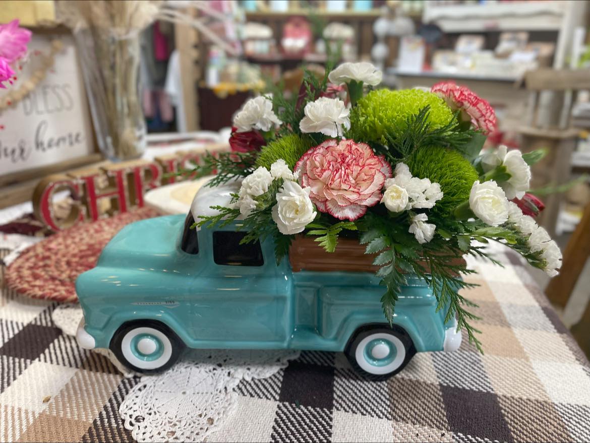 Seasons Greetings - Our Vintage Teal Chevy filled with Christmas blooms. Perfect for the holiday season the blooms will fade but they will forever have the keepsake chevy. 