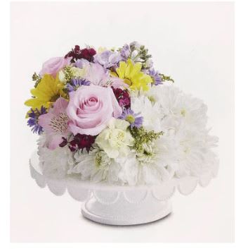 Cheerful Cascade Birthday Flower Cake - Here’s the recipe for a cheerful birthday! Our unique flower cake is gathered with a bed of bright white poms and a crescent-shaped cascade of sweet pastel blooms on one side. This confection-inspired creation is the perfect centerpiece for celebrating someone special. Add to the fun with a festive balloon.  ****** VASE PLATE WILL VARY ******
