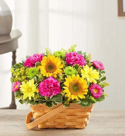 Sunny Garden Basket - There’s so much about a garden to inspire—vibrant colors, sweetly scented blooms... and that’s why we’ve captured it all in one charming basket! Filled with a beautiful mix of roses, sunflowers, daisies, and more, our hand-designed arrangement will inspire them to smile brighter, laugh longer... and delight in the moment forever. **BASKET WILL VARY**
