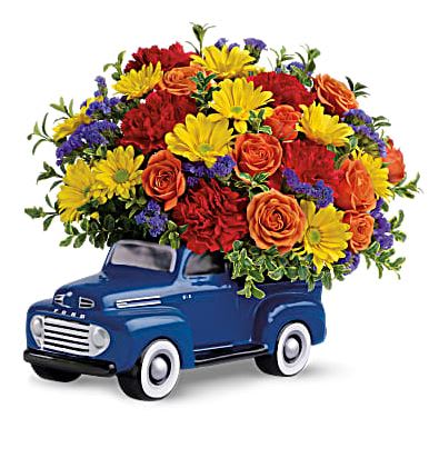 '48 Ford Pickup Bouquet - Beep, beep! Say "Happy Birthday," "Happy Father's Day," or "Keep on Truckin'!" to your favorite car buff with this whimsical bouquet, arranged in a reusable keepsake that will look great on his desk for years to come. Yellow daisies, orange roses, red carnations and purple statice are mixed with oregonia in Teleflora's charming ceramic replica of the legendary '48 Ford F-1 pickup. A fun way to send flowers to a man! Orientation: One-Sided