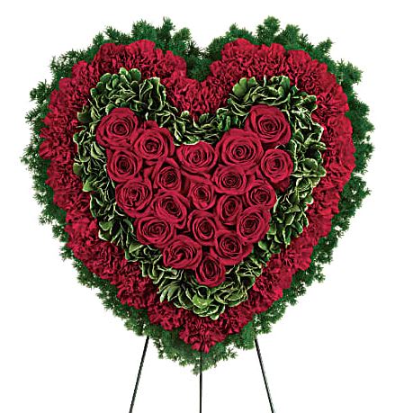 18" Majestic Heart - Speak from your heart. This majestic funeral display is a charming, heartfelt way to express your love, composed of sympathy red roses and carnations with variegated pittosporum and ming fern. Red carnations, red roses, variegated pittosporum and ming fern are arranged into a touching heart design that's presented on a wire easel.