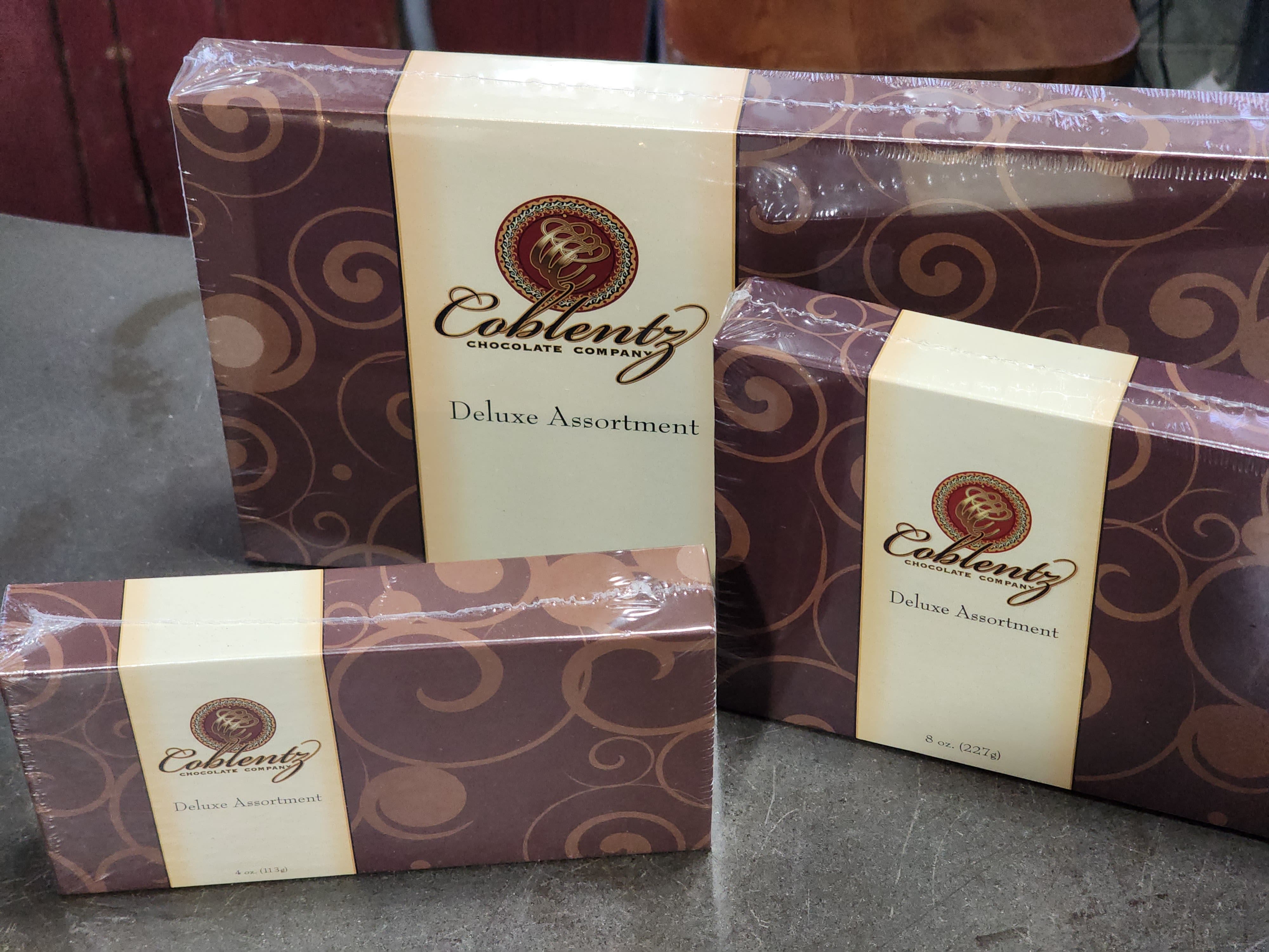 Three boxed assortments of chocolates with brown and cream packaging