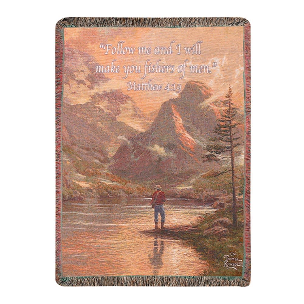 Woven blanket with a mountain scene and Bible verse text