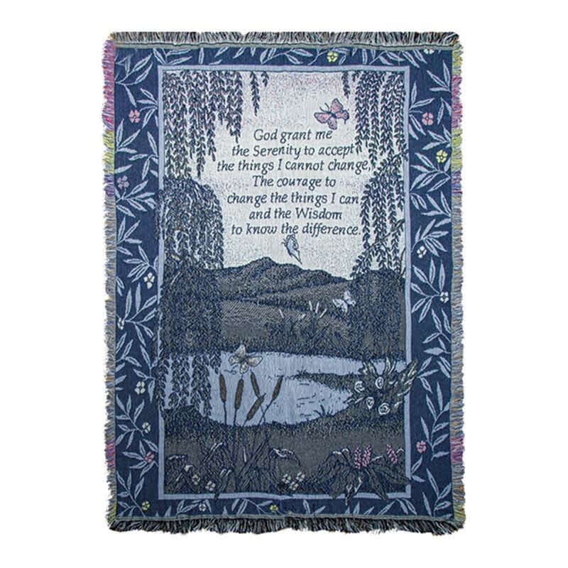 Blue woven blanket with a landscape scene and Serenity Prayer text