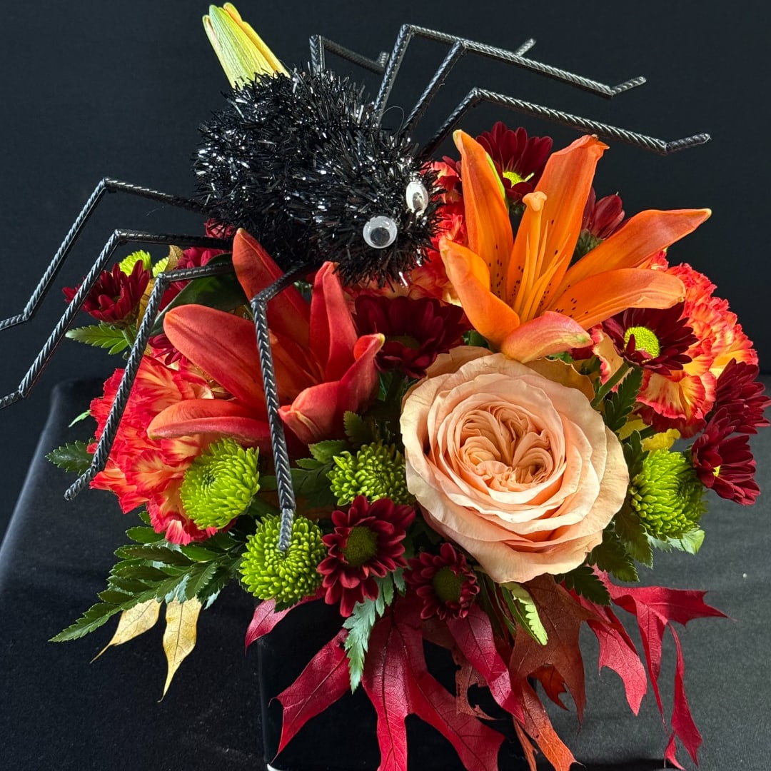 Halloween bouquet with a spider decoration and orange lilies