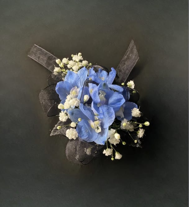 Northmont Light Blue Delphinium Corsage - A naturally blue flower that will compliment any outfit. The only flower color option for this boutonniere is light blue. Please select the wristlet color and up to 2 ribbon colors from the add-on selections you would like included. (Please do not select any of the flower color options)