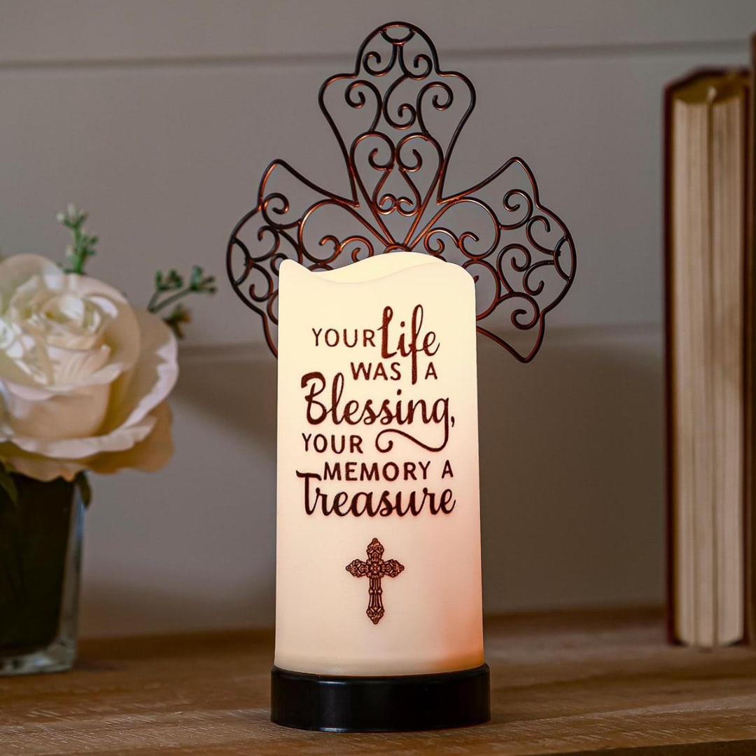 Memorial candle with a cross and decorative metal topper