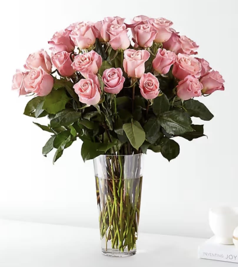 Pink roses arranged in a clear glass vase