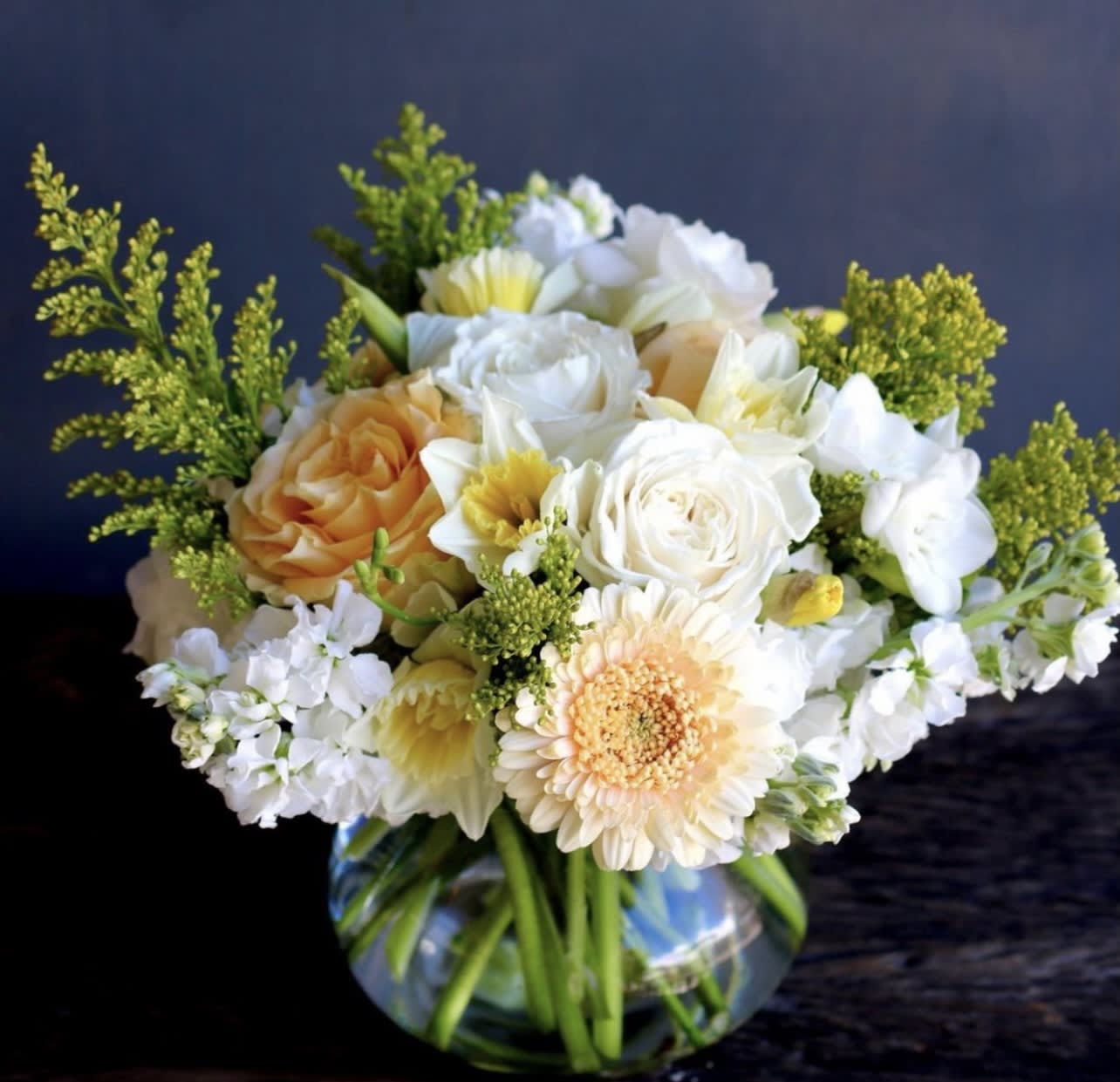 Bouquet of white and peach flowers in a glass vase