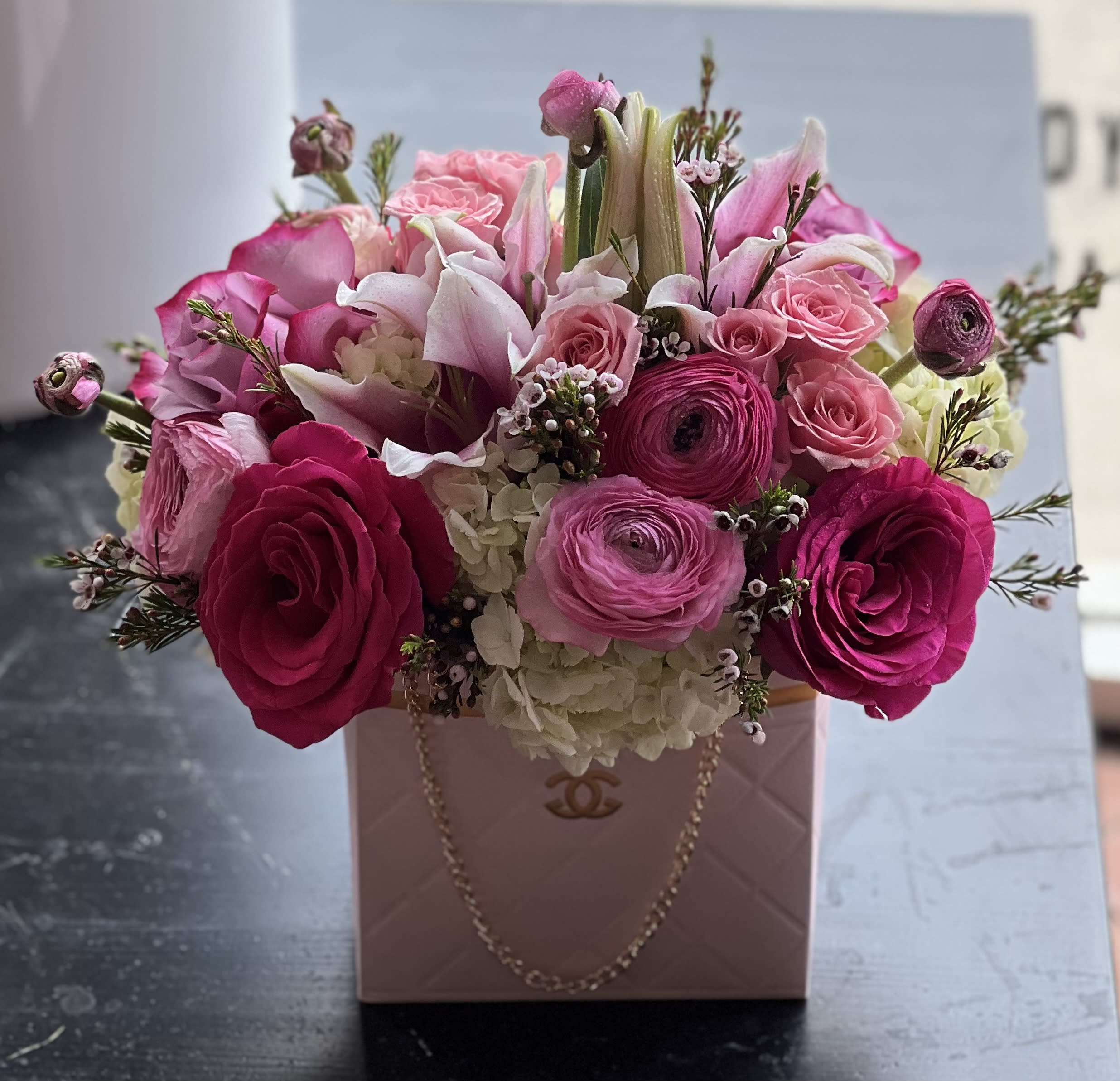 Pink and white flower arrangement in a blush handbag-style box