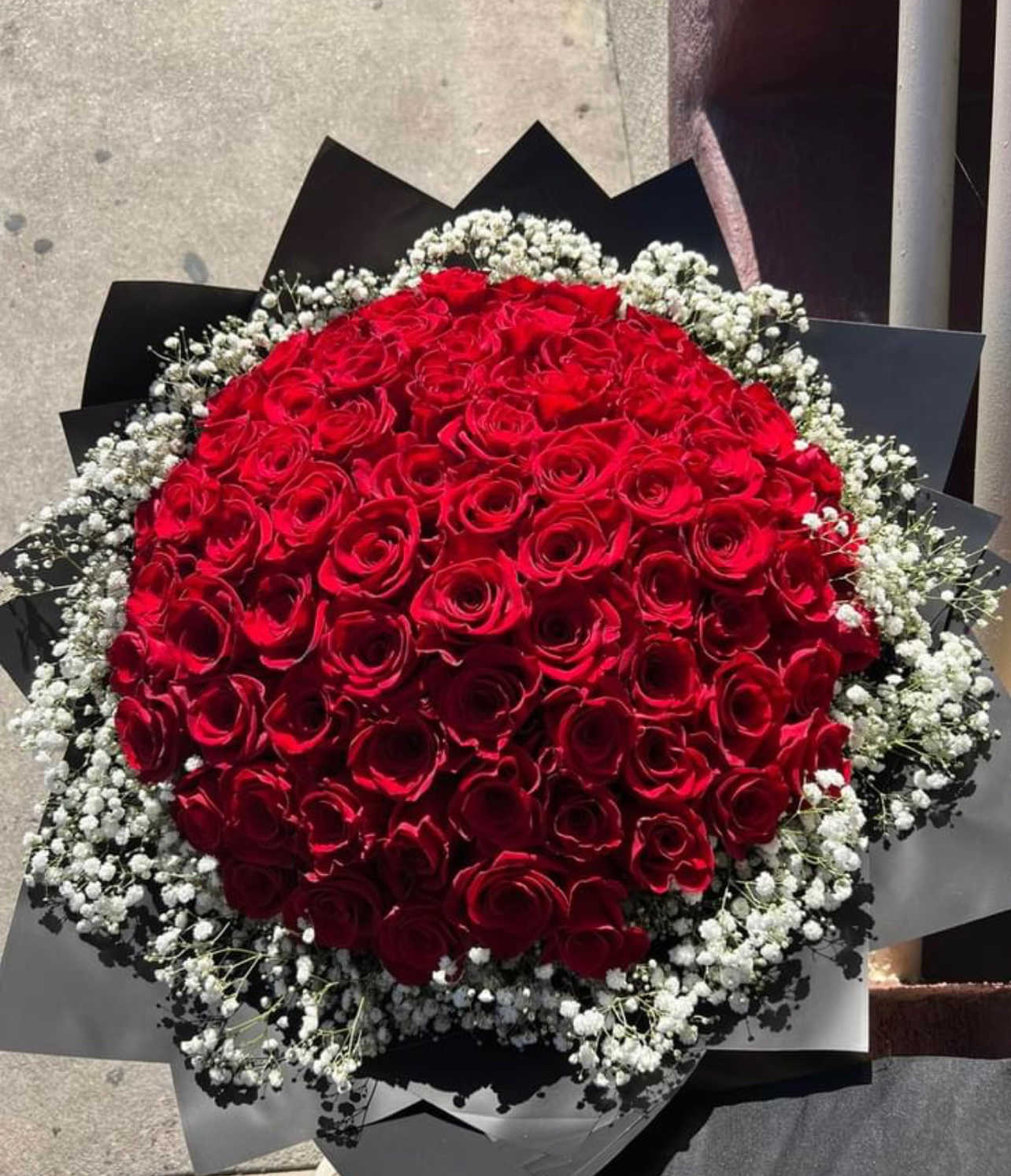 Large bouquet of red roses with white baby's breath