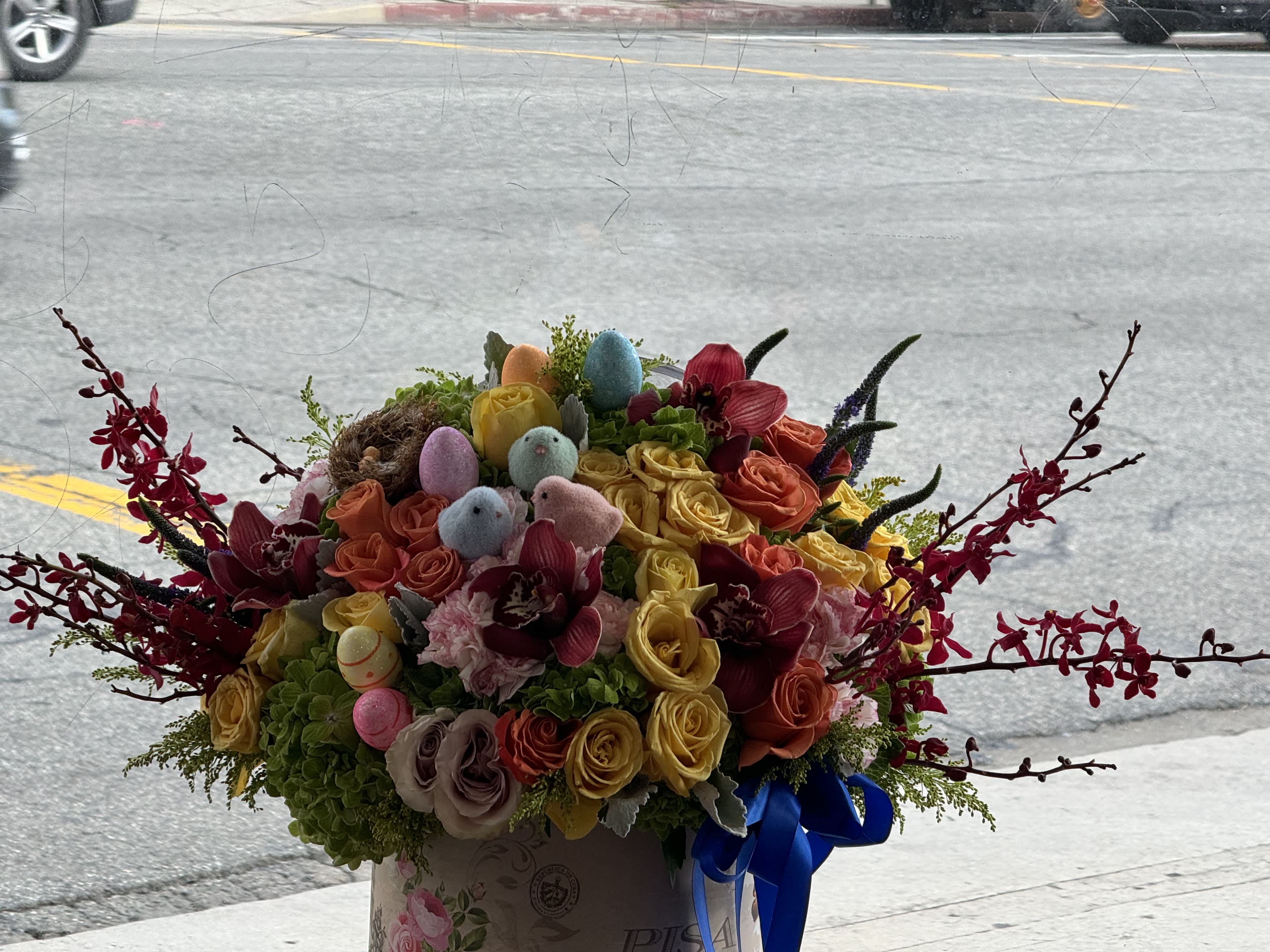 Colorful bouquet of roses with pastel Easter eggs in a box