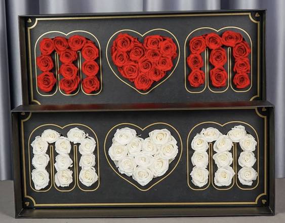 Two framed rose displays spelling MOM with a heart in the center.