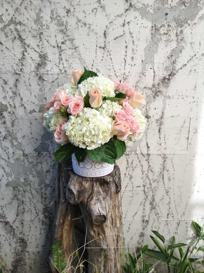 Dreamy Clouds - A well rounded array of white hydrangeas and pink roses, densely packed to create a dreamy cotton candy effect.