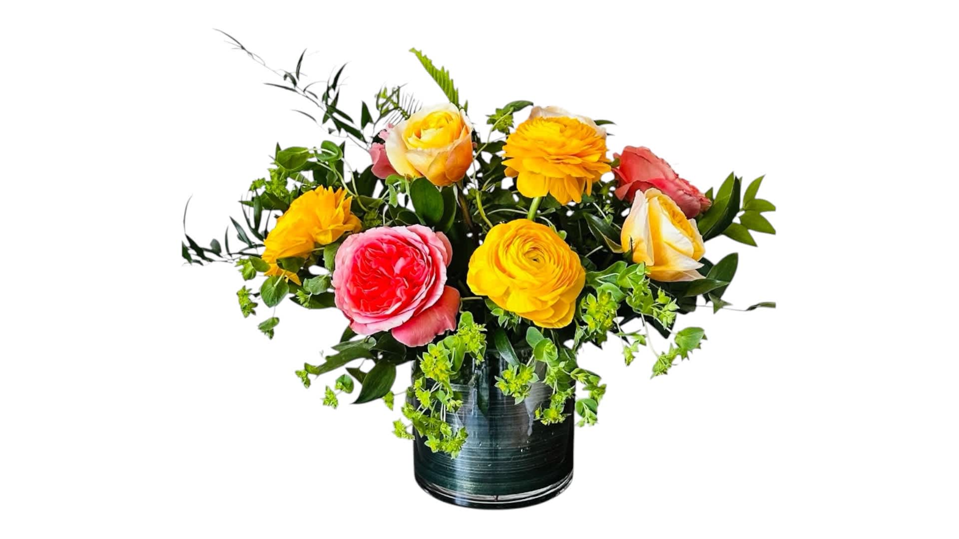 Mixed bouquet of bright roses in a dark glass vase