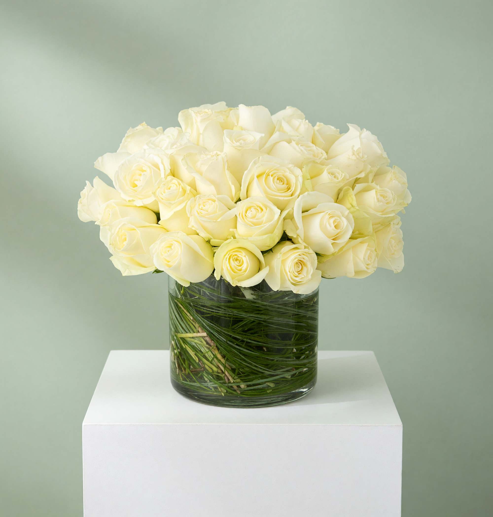 White rose bouquet in a clear glass vase