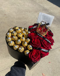 Heart-shaped box with red roses and gold-wrapped chocolates