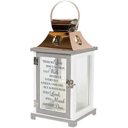Decorative white lantern with a copper top and glass panels