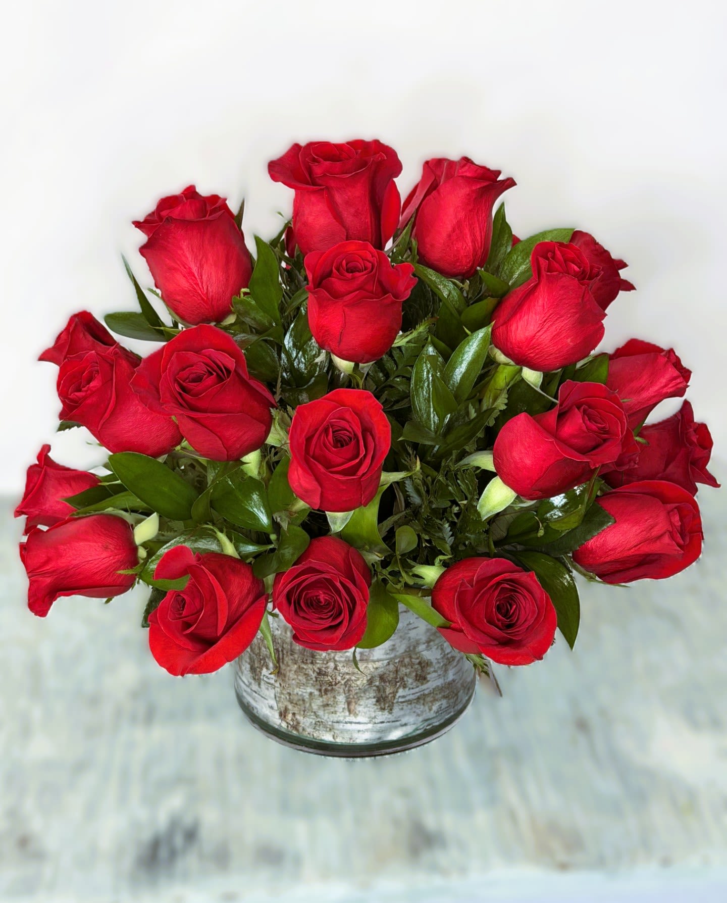 Bouquet of red roses in a rustic metal container