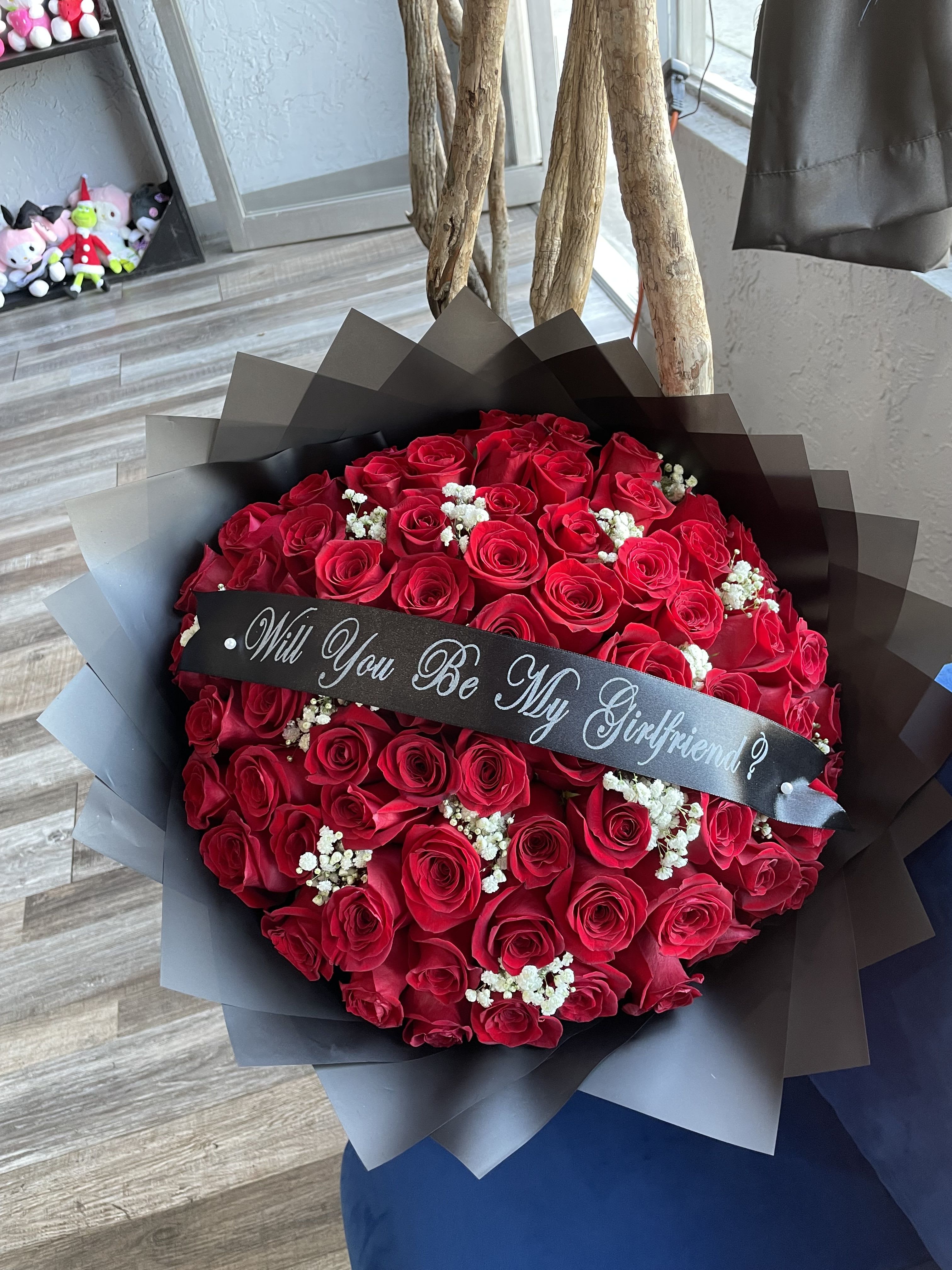 Bouquet of red roses with a black ribbon banner