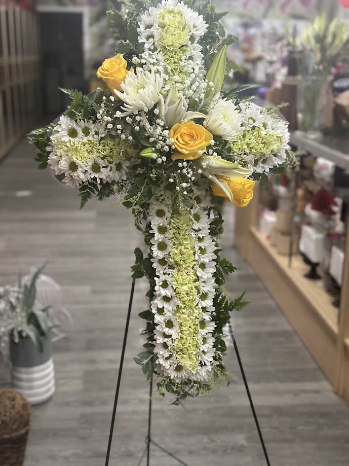 Cross-shaped floral standing spray with white daisies and yellow roses