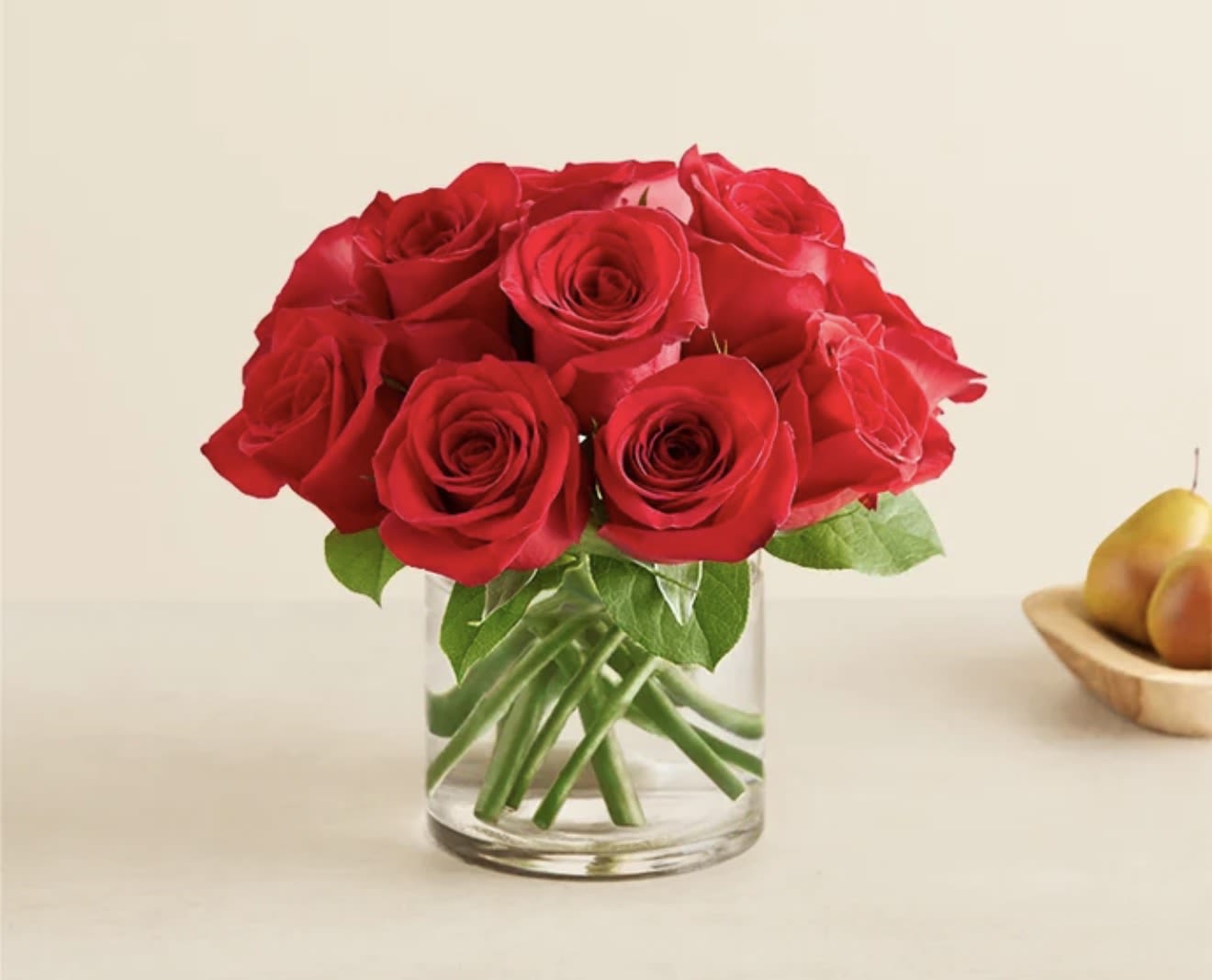 Red roses arranged in a clear glass vase