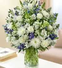 Florist Choice Blue &amp; White Sympathy Arrangement - A serene and elegant florist-choice sympathy arrangement featuring a beautiful selection of fresh seasonal flowers in calming blue and white tones, thoughtfully chosen by our florists for quality and design. Accented with fresh greenery, this arrangement creates a peaceful and dignified tribute.