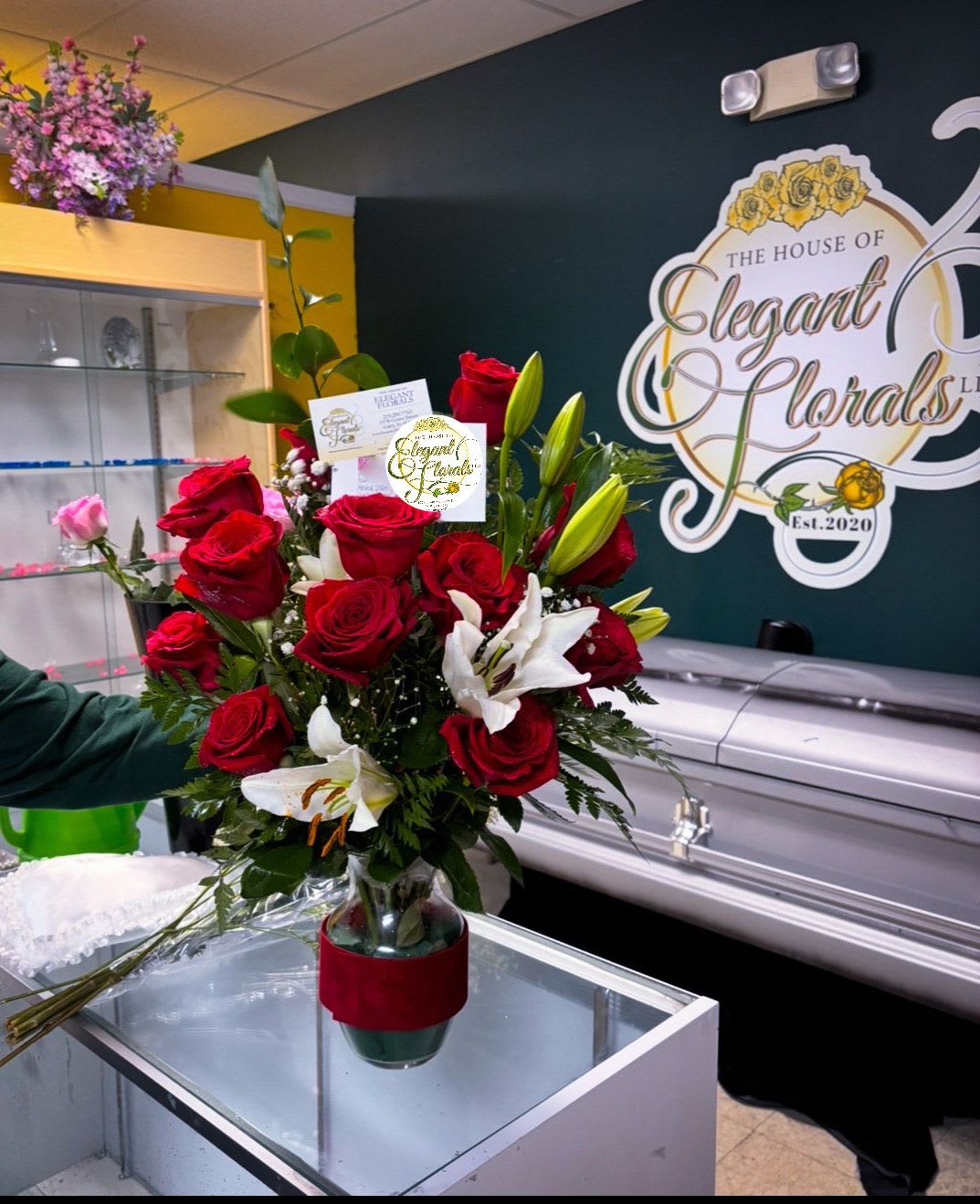 Bouquet of red roses and white lilies in a glass vase
