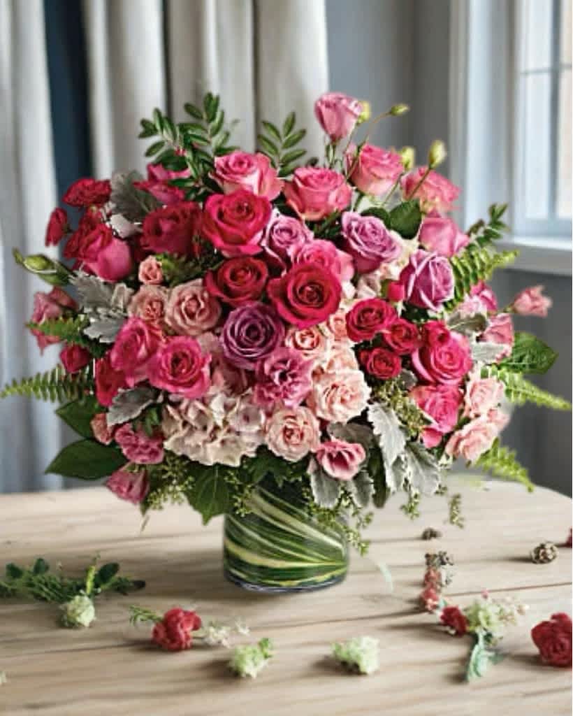 Pink and red rose arrangement in a glass vase
