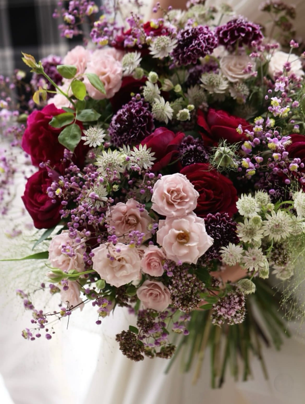 Bouquet of pink and burgundy roses with purple filler flowers