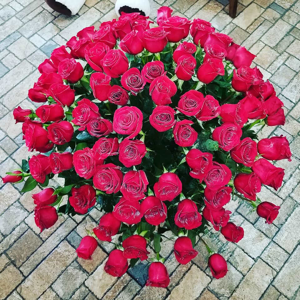 Large bouquet of red roses arranged in a round cluster