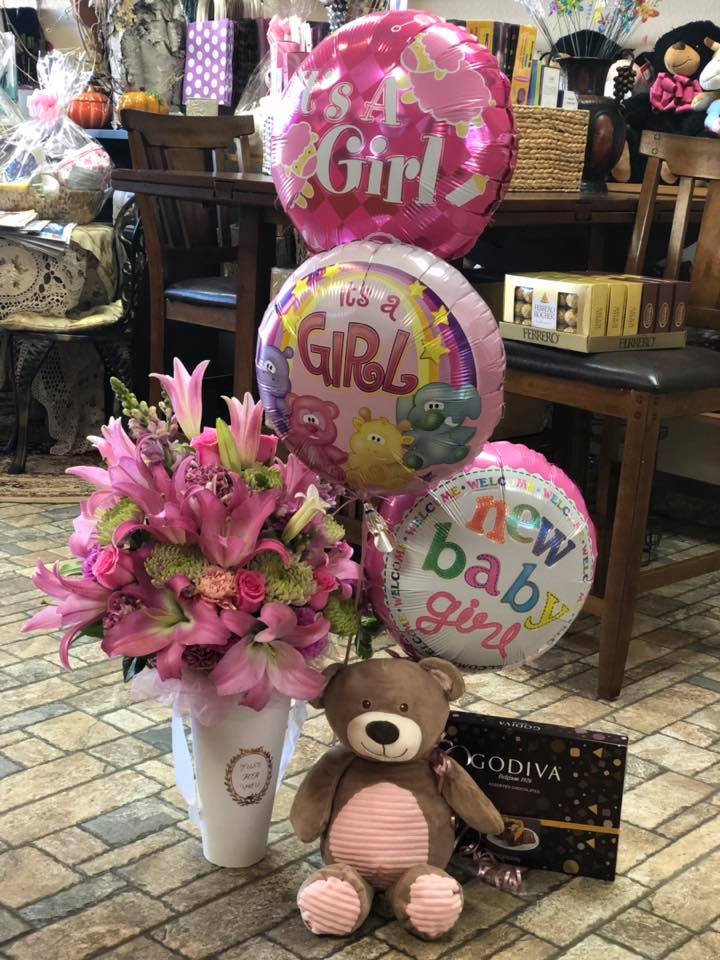 It's a Girl! New Baby Flower Arrangement with Vase and Balloon - Send the ultimate congratulatory gift for the new parents in your life. Includes everything needed to welcome a new bundle of joy into this world Balloons, Candy, Plush and Flowers!  Available for boy or gender neutral as well! 