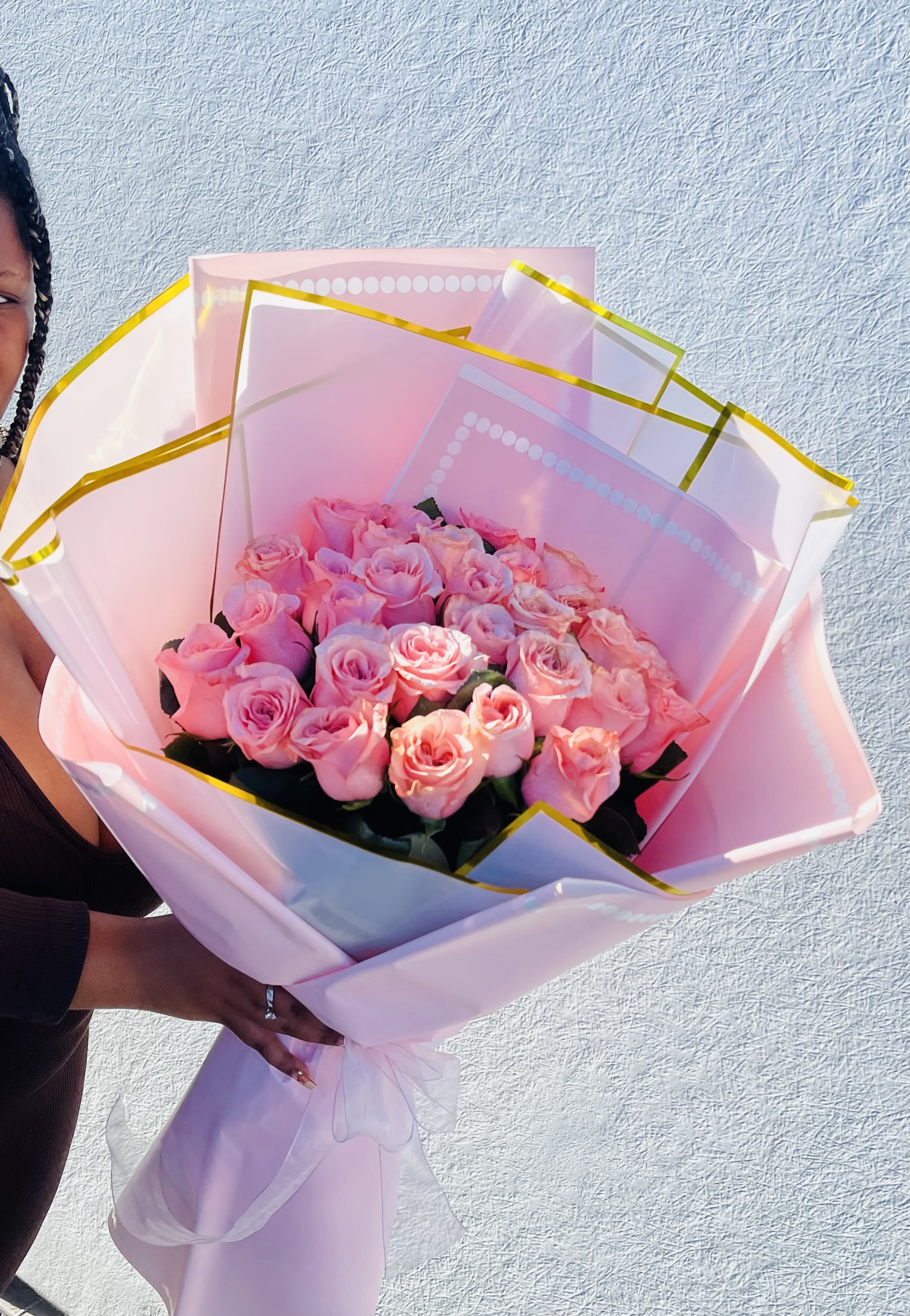 Little Princess Rose Garden Pink Rose Bouquet - A generous cluster of soft pink Roses gathered into a rounded, hand-tied flower arrangement makes a memorable birthday bouquet or a heartfelt "thinking of you" gift. This Little Princess Rose Garden Pink Rose Bouquet reads romantic and celebratory-perfect for anniversaries, graduations, new baby welcomes, or a simple "I'm sorry" when words aren't enough. She'll feel genuinely seen by the graceful sweep of petals and the classic pink tones that whisper admiration and gratitude.  The bouquet features tightly packed pink roses wrapped in layered pink and translucent white cellophane with a crisp gold-edged border, finished with a sheer white ribbon to create an elegant elongated cone of presentation. Also pictured are delicate white and yellow accents that brighten the composition. Hand-tied for easy carrying, this arrangement arrives ready to display in a vase; stems are long enough to settle into most standard vases. Ideal for spring and summer celebrations but lovely year-round, it's a thoughtful choice for wedding guests, prom dates, retirement parties, housewarmings, holiday greetings, or to lift someone's spirits when they're getting well. Divine Flowers &amp; Gifts delivers this bouquet across Killeen, TX for occasions large and small.