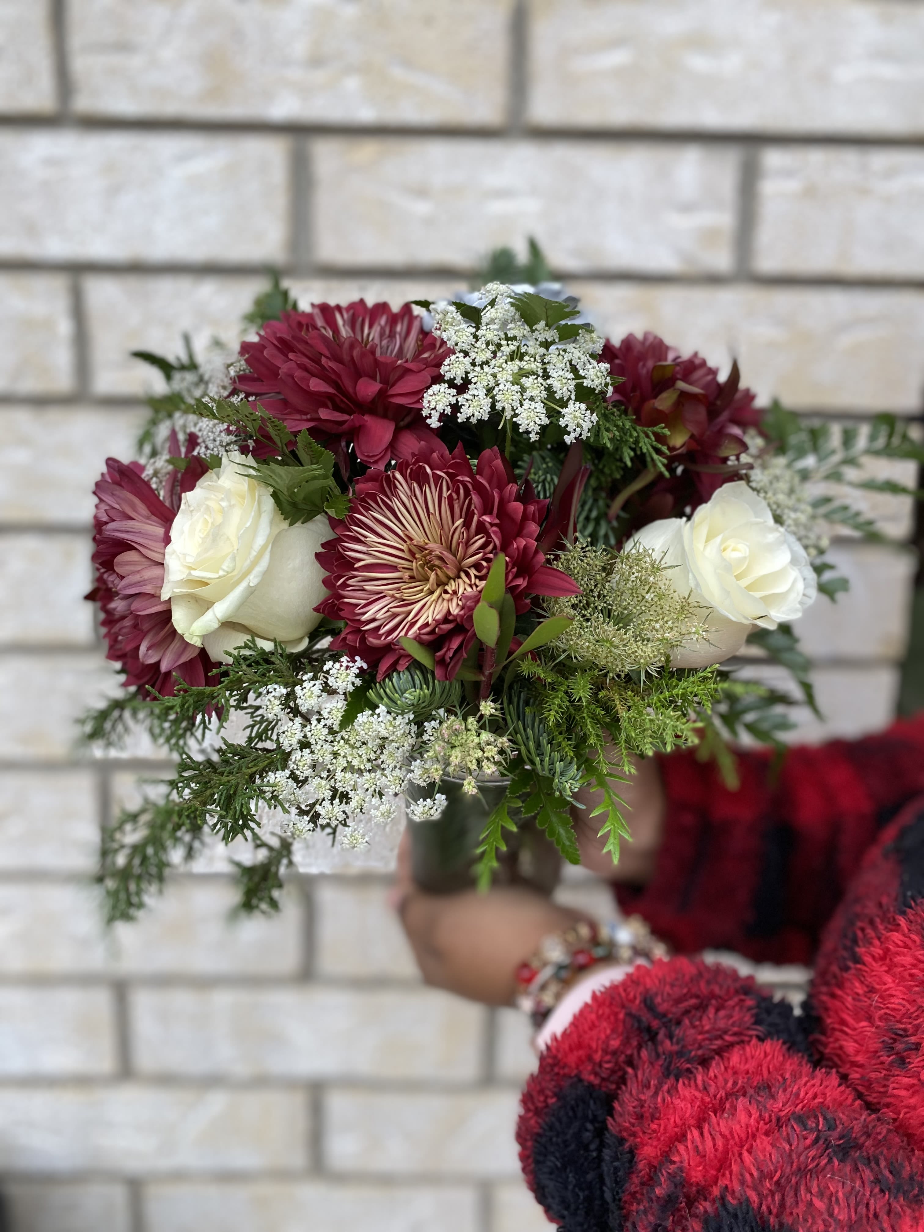 Bouquet of burgundy and white flowers with greenery