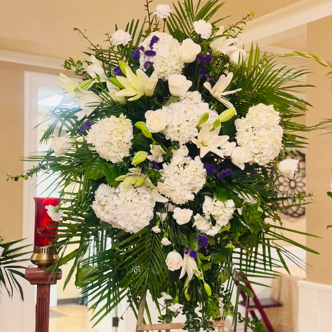 Large white floral standing spray with lilies and roses