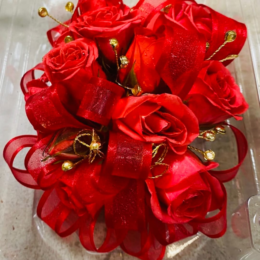 Red rose bouquet with ribbon and gold accents